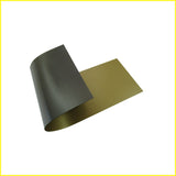 Photo shows piece of flexible gold colored magnetic material. Material is black on the magnetic side.